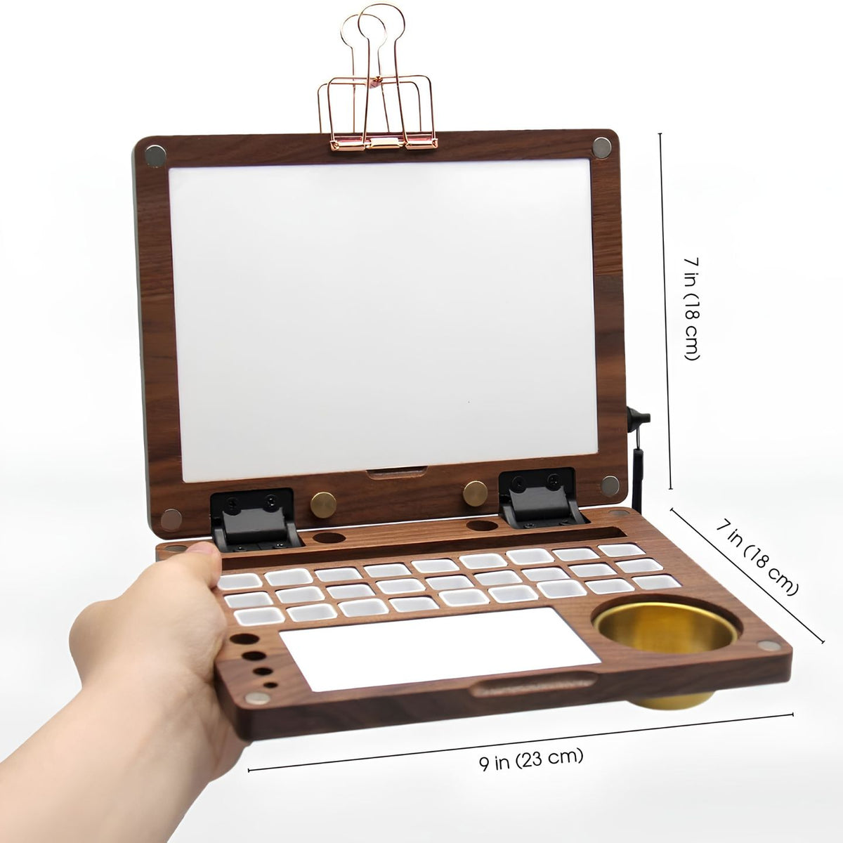 Open walnut watercolor box with size labels, 9 x 7 inches, empty paint grid and brass water pot